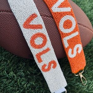 Orange with white lettering Vols purse strap
